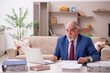 © Elnur - Old male employee working from home during pandemic