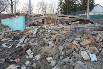 Wall Mural - a pile of garbage from old bricks and gray earth on the street