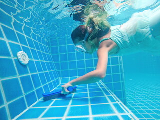 Picture of underwater pool cleaning.Service and maintenance of the pool.