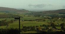 Yorkshire Landscape. Rolling Hills, Amazing Countryside View. Featuring Public Footpath Signage And Livestock. Cows. 