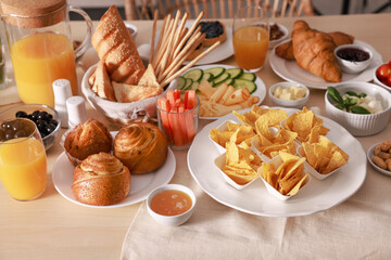 Dishes with different food on table indoors. Luxury brunch