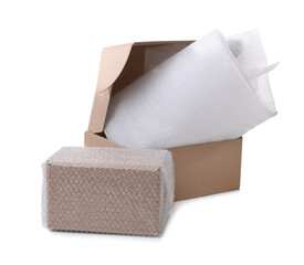 Cardboard boxes with bubble wrap and packaging foam on white background