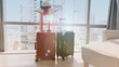 © SASITHORN - Two couple luggage as  a business trip and hat ,Holiday image  lens flare of the city building background, journey holiday concept