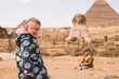 happy little girl and  boy plaing on background of Great Sphinx and Chephren's pyramid in Giza, Egypt