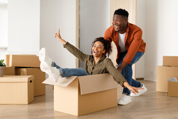 Wall Mural - Black Husband Riding Wife In Moving Box Celebrating Relocation Indoor