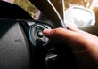 © BLKstudio - The driver presses the cruise control button on the car steering wheel with his hand