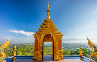 Wall Mural - Lanna style art of golden door facade entrance of Wat Phra That Doi Phra Chan. The Buddhist temple on the top hill of Doi Phra Chan mountain in Mae Tha, Lampang, Thailand.