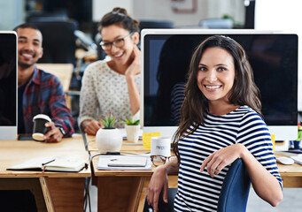 Poster - Make creativity a job. Portrait of a group of young office workers sitting at their computers.