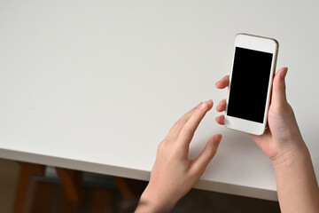 Poster - Top view of teenager hands holding a smart phone with a black screen.