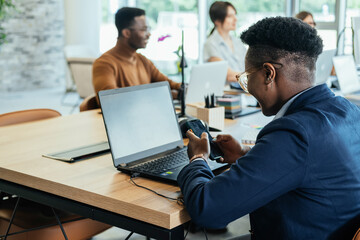 An Anonymous Business Woman Using Mobile Phone in Open Plan Office