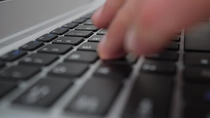 Extreme closeup of laptop keyboard, fingers typing text on it, camera rotating around. Partial view programmer or office worker or copywriter doing job on computer. Concept of technology