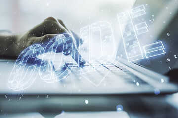 Poster - Creative Code word sign and hands typing on laptop on background, international software development concept. Multiexposure