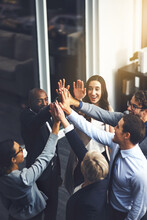 Were Going To Succeed No Matter What. Shot Of A Group Of Businesspeople High Fiving In An Office.