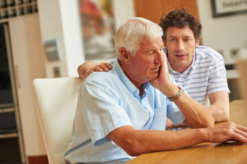 Poster - There to support each other. Shot of a man consoling his senior father at home.