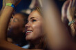 © Tasneem H/peopleimages.com - Shot of a young woman in a crowd at a concert. This concert was created for the sole purpose of this photo shoot, featuring 300 models and 3 live bands. All people in this shoot are model released.