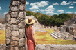 A young woman tourist stands against the backdrop of the Mayan ruins in the ancient city of Edzna.Edzna Campeche Mayan pyramids in Mexico. Travel concept.