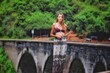 girl on a nine arche bridge in sri lanka ella