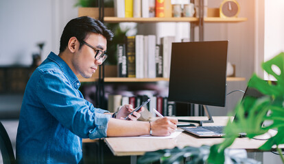 Sticker - Young Asian man working at office