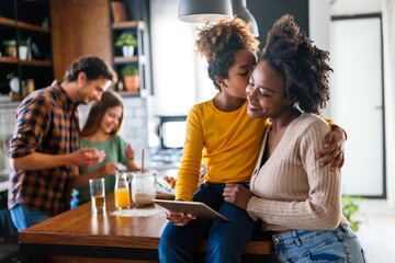 Wall Mural - Happy multiethnic family having fun while cooking and using digital tablet at home