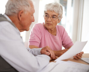 Poster - Taking time to discuss important matters. Shot of two elderly people discussing a document.