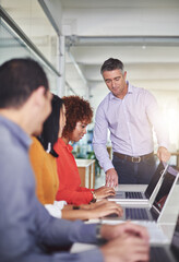 Wall Mural - Let me give you a few pointers. Cropped shot of a man addressing his employees in the office.