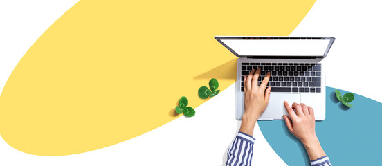 laptop computer with shamrock leaves - flat lay