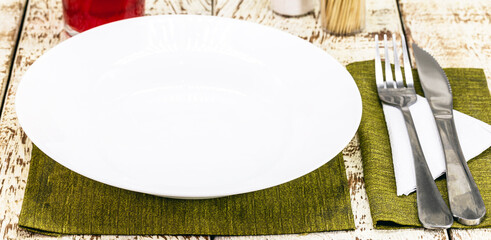 top view rustic white table mockup, empty round and white plate for food, cutlery on the side, vintage backdrop, homemade food concept