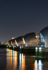 Wall Mural - A vertical shot of the thames barrier at night in London