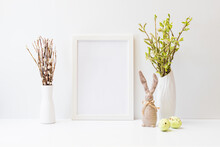 Home Interior With Easter Decor. Mockup With A White Frame And Willow Branches In A Vase On A Light Background