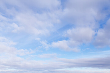 Beautiful epic soft gentle blue sky with white and grey cirrus and fluffy clouds background texture