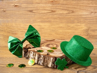 Shamrock clover and green hat on a wooden table, symbol of the Irish holiday of St Patrick's Day.