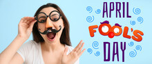 Young Woman In Funny Disguise On Blue Background. April Fools' Day Celebration
