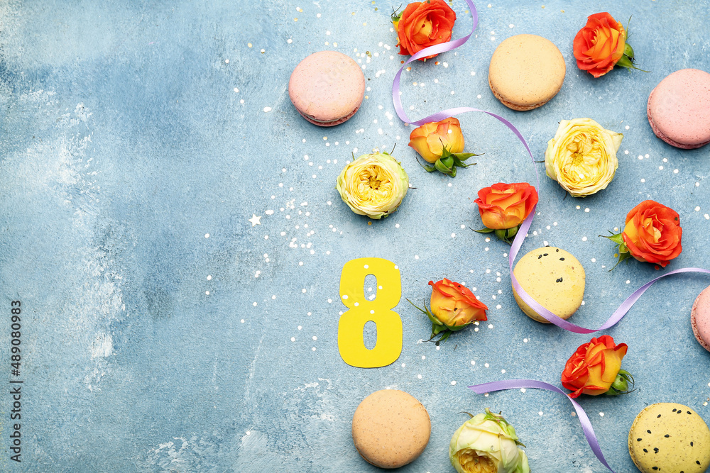 Composition with beautiful rose flowers and sweet macaroons on color background. International Women's Day celebration