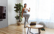 © Louis-Paul Photo - African american woman working out in home livingroom gym