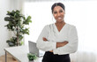 © Louis-Paul Photo - young African American businesswoman working at laptop at home office