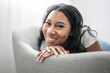 © Louis-Paul Photo - Attractive young African woman sitting on the couch at home