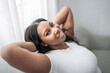 © Louis-Paul Photo - Attractive young African woman sitting on the couch at home