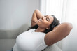 © Louis-Paul Photo - Attractive young African woman sitting on the couch at home