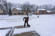Man Clears Driveway In Snowy Midwest Winter
