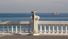 Coin Operated Metal Tower Viewer Binoculars On A Stalk On The Seafront Looking Out To Sea At An Anchored Ship Sardinero Santander Cantabria Spain