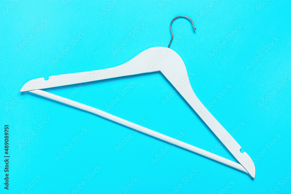 Clothes hanger on blue background