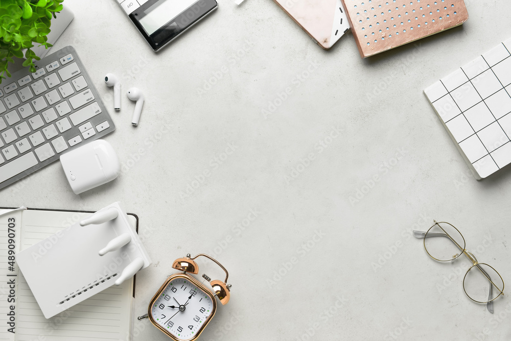 Wi-Fi router, keyboard and stationery on light background