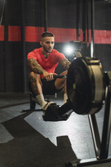 Wall Mural - Young attractive Caucasian man exercising at the gym