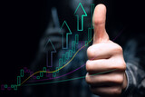 Fototapeta Młodzieżowe - An investor with a phone shows a thumbs up, against the backdrop of an ascending graph with high volatility and moving averages. Bullish trend with lines and arrows.