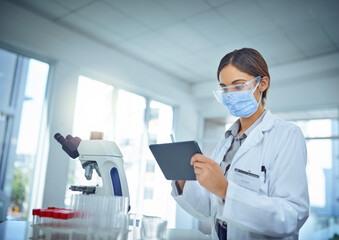 Poster - Making it easier to publish her findings to the world. Shot of a female scientist using a digital tablet in a lab.