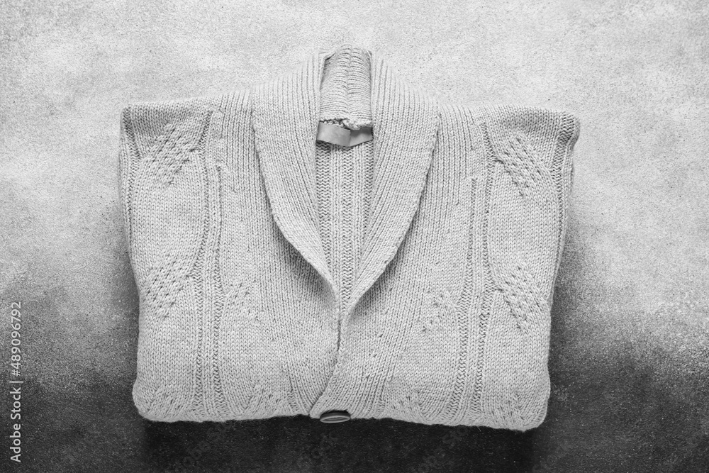 Stylish sweater on black and white background