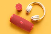 Modern Wireless Portable Speakers And Headphones On Color Background