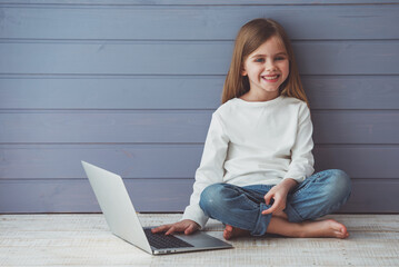 Wall Mural - Little girl with gadget