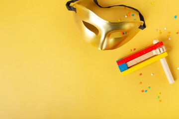 purim celebration concept on yellow background, jewish carnival. top view, flat lay