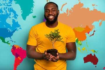 Wall Mural - Man holds and takes care of a small tree